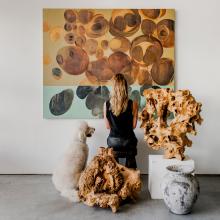 woman and dog looking at painting 