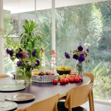 Table full of fruit, plants, and plates 