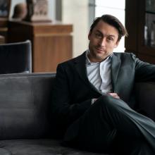 man in suit sitting 