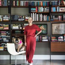 Chelsea Handler in front of a bookcase with her dog 