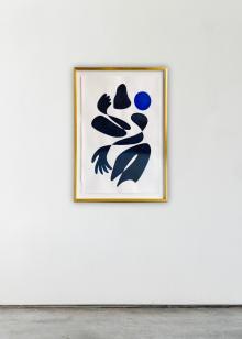 A gallery wall featuring a framed painting by artist Kellie Lawler in black and blue on white paper in a brass frame. 