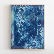 A vertical rectangular abstract painting by Kristen Abbott, featuring a predominantly blue color palette. White and lighter blue streaks and shapes create a dynamic, textured effect across the canvas, resembling leaves and organic patterns akin to cyanotype artwork. The painting is framed with a thin border.