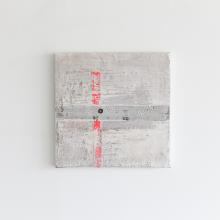 River Crossing Rivers by Patricia Larsen is a square concrete slab with a small, dark circular hole in the middle. A vertical red line bisects the slab while a horizontal red line intersects it just above the center. With its minimalist design and striking contrast, this piece evokes a contemporary abstract painting by Canadian artist Patricia Larsen.